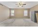 Bright bedroom with ceiling fan, carpeted floors, and two windows at 8876 W Bluefield Ave, Peoria, AZ 85382