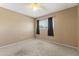 Bedroom with neutral walls, carpeting, and window with black curtains to control natural light at 8876 W Bluefield Ave, Peoria, AZ 85382