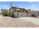 Charming two-story home with a two-car garage and desert landscaping in the front at 8876 W Bluefield Ave, Peoria, AZ 85382