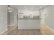 Spacious kitchen with an island, white appliances and cabinetry, with tile flooring at 8876 W Bluefield Ave, Peoria, AZ 85382