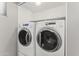 Washer and dryer, a side-by-side set, in a dedicated laundry room space at 8876 W Bluefield Ave, Peoria, AZ 85382