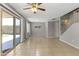 Bright living room with tile flooring, ceiling fan and sliding door to the backyard patio at 8876 W Bluefield Ave, Peoria, AZ 85382