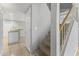 View of a carpeted staircase with gray walls and a view into the adjacent kitchen area at 8876 W Bluefield Ave, Peoria, AZ 85382