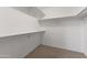 Walk-in closet with built-in shelving provides ample storage space for clothes and accessories at 8876 W Bluefield Ave, Peoria, AZ 85382
