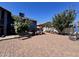 Large brick patio in a well-kept backyard, featuring seating and greenery at 8908 W Sheridan St, Phoenix, AZ 85037