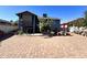 Backyard showing a brick patio with outdoor seating and mature landscaping at 8908 W Sheridan St, Phoenix, AZ 85037