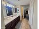 Bathroom with dual sinks and a walk-in shower at 8908 W Sheridan St, Phoenix, AZ 85037