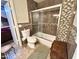 Neutral bathroom featuring a tiled shower/tub combo and elongated toilet at 8908 W Sheridan St, Phoenix, AZ 85037