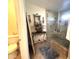 Modern bathroom with a glass-enclosed shower, decorative accents, and a neutral color scheme at 8908 W Sheridan St, Phoenix, AZ 85037