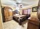 Bedroom featuring dark wood furniture and tile floors at 8908 W Sheridan St, Phoenix, AZ 85037