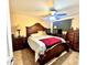 Cozy bedroom with ceiling fan and dark wood furniture at 8908 W Sheridan St, Phoenix, AZ 85037