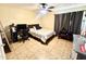 Functional bedroom with a desk, storage, and a comfortable bed, ideal for a teenager or guest at 8908 W Sheridan St, Phoenix, AZ 85037