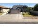 Inviting two-story home featuring a large driveway and solar panels for energy efficiency at 8908 W Sheridan St, Phoenix, AZ 85037