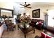 Cozy living room featuring a ceiling fan, stylish decor, and comfortable seating at 8908 W Sheridan St, Phoenix, AZ 85037