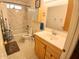 Well-lit bathroom featuring tile surround tub/shower combo and vanity at 9726 E Quarterline Rd, Mesa, AZ 85207