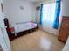 Bright bedroom featuring wood-look floors, ample light, and space for dresser at 9726 E Quarterline Rd, Mesa, AZ 85207