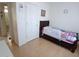 Cozy bedroom with wood-look floors and nearby bathroom at 9726 E Quarterline Rd, Mesa, AZ 85207