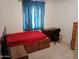 Bedroom featuring blue curtains, desk, and a wooden dresser at 9726 E Quarterline Rd, Mesa, AZ 85207