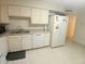 Spacious kitchen with white cabinets, modern appliances, and practical layout for cooking and dining at 9726 E Quarterline Rd, Mesa, AZ 85207