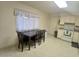 Bright eat-in kitchen featuring a dining table, natural light, and white appliances for a welcoming space at 9726 E Quarterline Rd, Mesa, AZ 85207