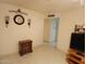 Neutral living room with tile flooring, featuring a small cabinet and adjacent open doorway at 9726 E Quarterline Rd, Mesa, AZ 85207