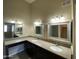 Bathroom featuring double sinks, granite countertops and decorative mirrors at 10136 E Southern Ave # 3109, Mesa, AZ 85209