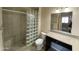 Bathroom showcasing a glass block shower, granite counters, and neutral tile flooring at 10136 E Southern Ave # 3109, Mesa, AZ 85209