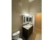 Powder room featuring tile floors, dark wood vanity with light granite counter, and framed mirror at 10136 E Southern Ave # 3109, Mesa, AZ 85209