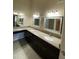 Bathroom featuring dual sinks, granite countertop, and ample cabinet storage at 10136 E Southern Ave # 3109, Mesa, AZ 85209