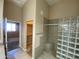 Bathroom featuring glass block shower and open doorway to the walk-in closet at 10136 E Southern Ave # 3109, Mesa, AZ 85209