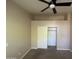 A neutral bedroom features a ceiling fan, closet, and carpeted floor at 10136 E Southern Ave # 3109, Mesa, AZ 85209
