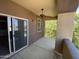 Private covered patio with ceiling fan, sliding glass doors, and a glimpse of greenery outside at 10136 E Southern Ave # 3109, Mesa, AZ 85209