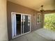 Private covered patio with ceiling fan, sliding glass doors, and a glimpse of greenery outside at 10136 E Southern Ave # 3109, Mesa, AZ 85209