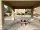Community picnic table under a covered patio near the basketball court and apartments at 10136 E Southern Ave # 3109, Mesa, AZ 85209