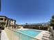 A community pool and hot tub surrounded by lounge chairs, tables, and a ramada with solar panels at 10136 E Southern Ave # 3109, Mesa, AZ 85209