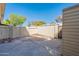 Enclosed backyard with hardscape, block fencing, and mature trees at 1061 E Fremont Dr, Tempe, AZ 85282