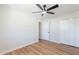 A bright bedroom with hardwood floors, ceiling fan, and a closet for ample storage space at 1061 E Fremont Dr, Tempe, AZ 85282