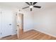 A bright bedroom with hardwood floors, ceiling fan, and a closet for ample storage space at 1061 E Fremont Dr, Tempe, AZ 85282