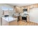 Modern kitchen with stainless steel appliances, quartz countertops, and light wood cabinets at 1061 E Fremont Dr, Tempe, AZ 85282