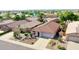 Aerial view of home with a tile roof, desert landscaping, and two-car garage at 10786 W Chisholm Dr, Sun City, AZ 85373