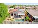 Aerial view of a property featuring solar panels, a private pool, covered patio, and lush backyard landscaping at 10786 W Chisholm Dr, Sun City, AZ 85373