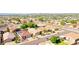 An aerial view of homes with well-maintained yards and a nearby lake at 10786 W Chisholm Dr, Sun City, AZ 85373