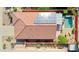 Aerial view of a home with a red-tiled roof, solar panels, a private pool, and a beautifully landscaped backyard at 10786 W Chisholm Dr, Sun City, AZ 85373