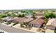 Aerial view showcasing landscaped front yards, tile roofs, and nearby community lake at 10786 W Chisholm Dr, Sun City, AZ 85373