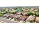 Aerial view of homes with desert landscaping, tile roofs, and a community lake at 10786 W Chisholm Dr, Sun City, AZ 85373