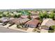 Aerial view of homes with desert landscaping, tile roofs, and community lake at 10786 W Chisholm Dr, Sun City, AZ 85373