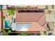 Aerial view showcasing a home's tile roof, solar panels, refreshing private pool, and well-maintained yard at 10786 W Chisholm Dr, Sun City, AZ 85373