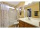 Clean bathroom with a shower-tub combo, a wood vanity with a sink, neutral walls, and a framed mirror at 10786 W Chisholm Dr, Sun City, AZ 85373