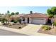 Attractive single-story home featuring desert landscaping, a tile roof, and a paved driveway leading to an attached garage at 10786 W Chisholm Dr, Sun City, AZ 85373