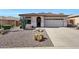 Charming single-story home showcasing desert landscaping and a two-car garage at 10786 W Chisholm Dr, Sun City, AZ 85373